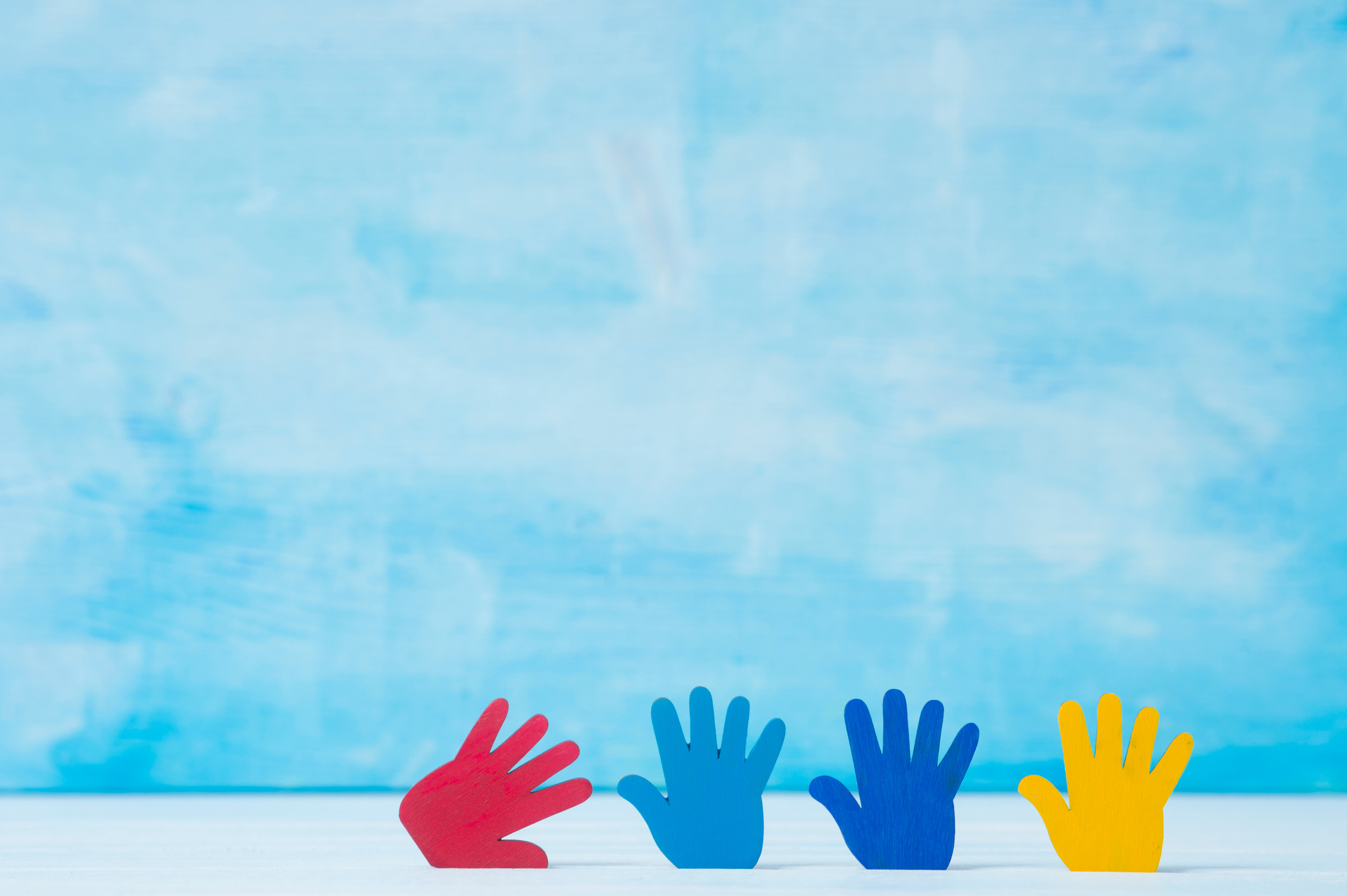 Colorful Hands on Blue Background